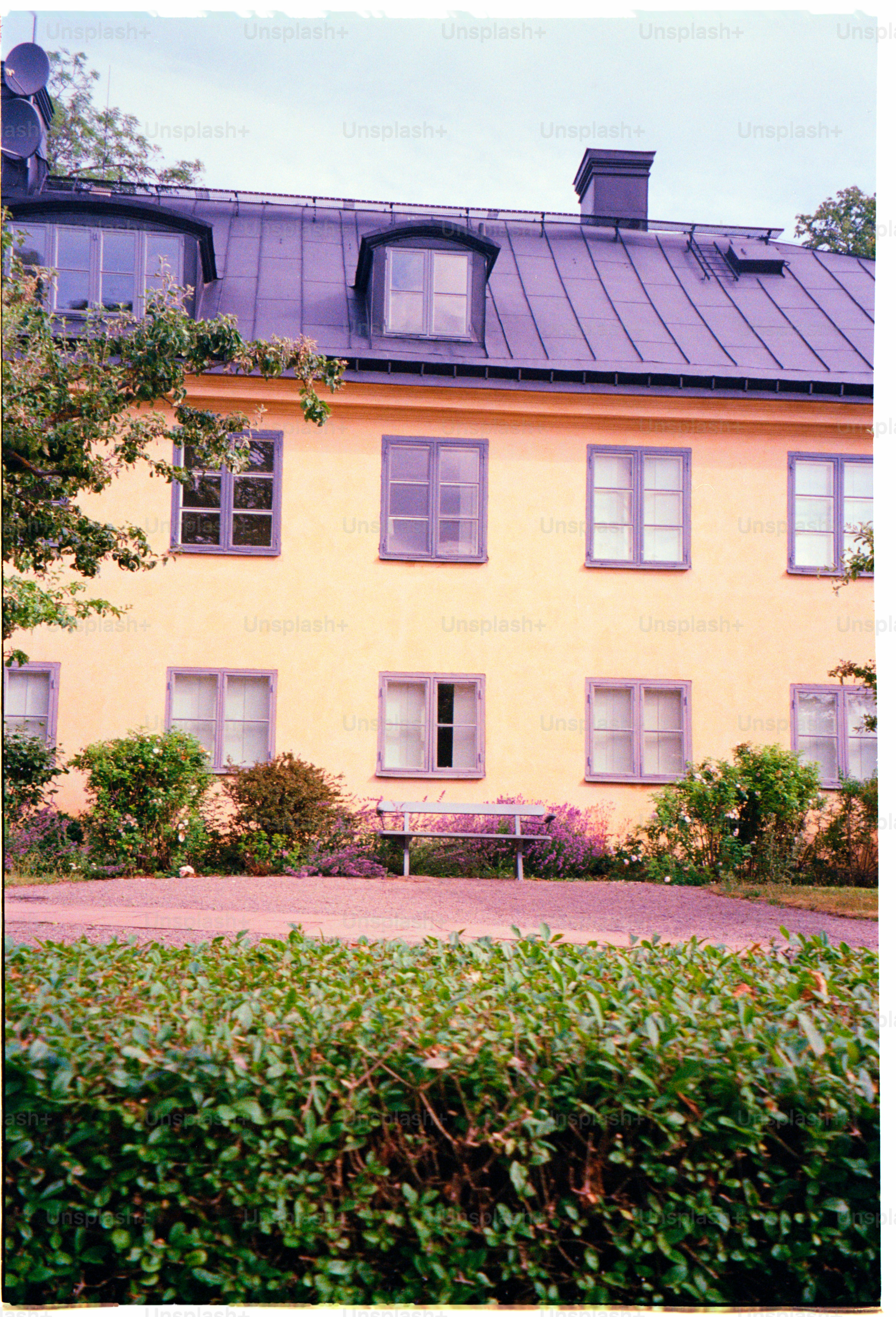 A yellow building with many windows